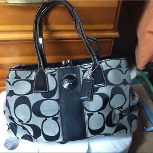 Coach bag with coach print and leather handles